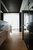 Rectangular sinks and wood-effect tiles in modern bathroom