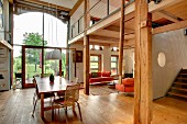 Open-plan interior with rustic, modern atmosphere, gallery and glazed barn door