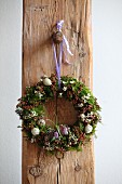 Easter wreath hung on rustic wooden beam