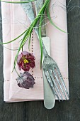 Broderie anglaise napkin, vintage cutlery and snake's head fritillaries