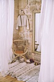 Cosy dressing room with exposed stone wall and rug
