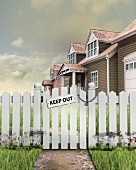 Keep Out sign on padlocked gate outside of house