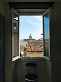 View through open window over the rooftops of Florence