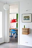 View into modern dining room in bold colours from hallway