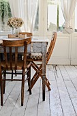 Vintage dining table and wooden chairs on wooden floor