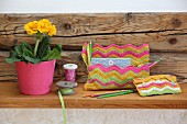 Two crocheted bags with colourful zigzag patterns