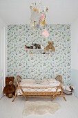 Vintage-style floral wallpaper and rattan bed in child's bedroom