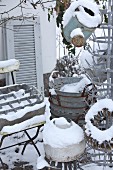 Collection of zinc objects in snowy garden