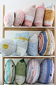 Various, crocheted, pastel cushions made from T-shirt yarn