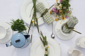 Table set with posy of colourful wildflowers and arranged napkins