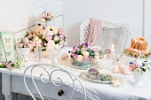 Easter table romantically set with delicate flowers and lit candles