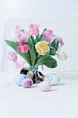 Bouquet of tulips and decorated Easter eggs