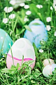 Easter eggs in pastel shades amongst grass