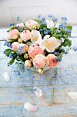 Spring bouquet with forget-me-nots on blue wooden boards