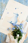Posy of forget-me-nots on card with picture of coffee pot