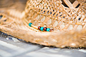 Detail of straw hat with bead detail