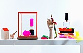 Still-life arrangement of neon accessories and books