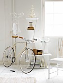 Bicycle, coat stand and chair in white interior