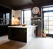 Black glossy cabinets and white floor in kitchen