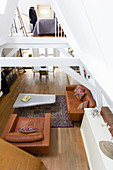 View from gallery down into living area with cognac leather seating