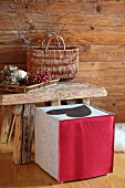 Stool with hand-made felt cover in rustic cabin-style interior