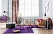Living room with leather sofa, purple rugs and purple sideboard