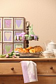 Pastries on vintage cake stand and Easter ornaments on top of chest of drawers