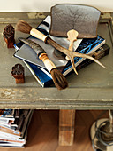 Brushes with horn handles and books stacked on table