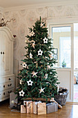 Presents under Christmas tree decorated with stars