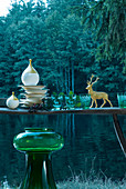 Ornaments on table next to lake in woods