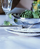 Place setting with shiny bowl on white table mat
