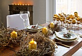 Several rustic wreaths and gold candles decorating festive table