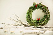 Hand-made wreath of herbs decorated with chillies and tealight holders