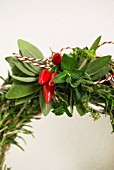 Hand-made wreath of herbs decorated with chillies (detail)