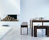 Wooden dining set in front of white open fireplace