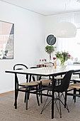 Various black chairs around simple dining table