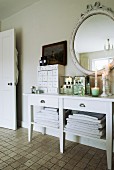 Vintage-style accessories on white console table in bathroom