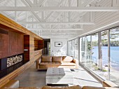 Living room in modern, architect-designed house with exposed roof structure