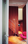 Pink swivel chair and staircase