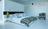 White bedroom with wooden walls and floor