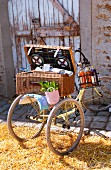 Picnic basket on tricycle on straw in front of barn
