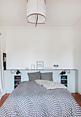 Double bed with polka-dot bed linen in bedroom