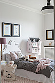 Dolls' house in elegant, French-style child's bedroom