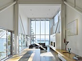 Wohnbereich in experimentellem Strandhaus mit Panoramaverglasung und Meerblick