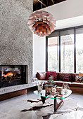 Designer furniture in the earth-colored living room with built-in fireplace