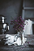 Flowers in water in a country kitchen