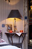 Table lamp made from zebra's leg and hoof on bedside table in rustic interior