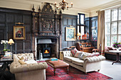 Historical panelled wall and open fireplace in living room
