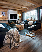 Modern furniture in cosy living room of log cabin
