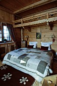 Uriges Schlafzimmer in einem Chalet mit Holzwänden